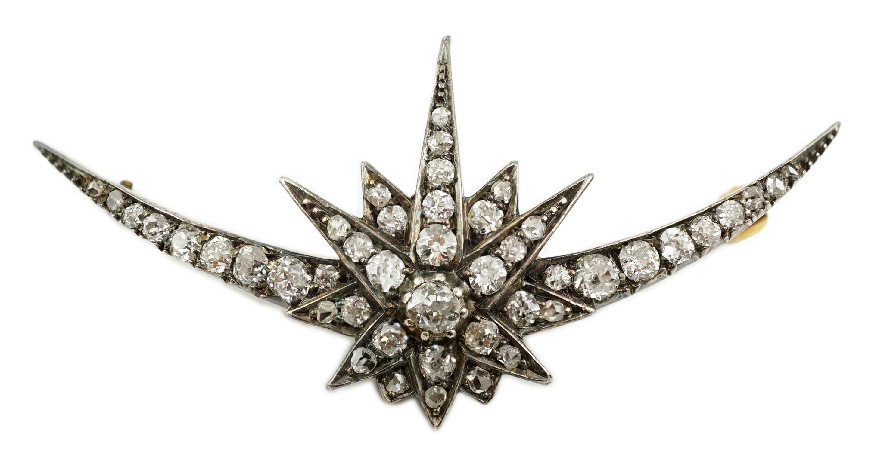 A Victorian gold, silver and graduated diamond cluster set crescent and starburst brooch